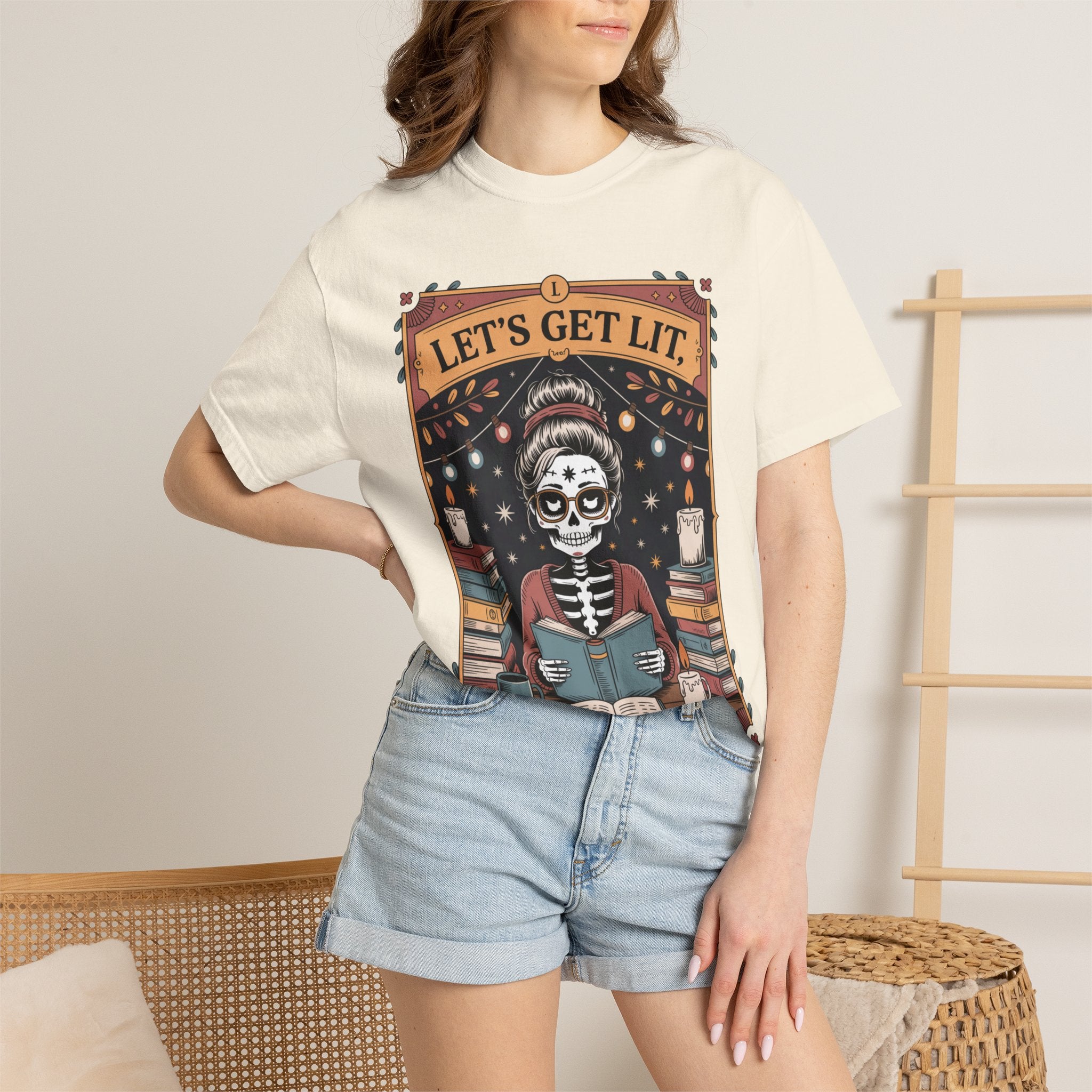 Person wearing a t-shirt with a skeleton reading a book graphic and 'Let's Get Lit' text.