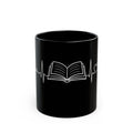Black mug with a white book and heartbeat line design on a white background