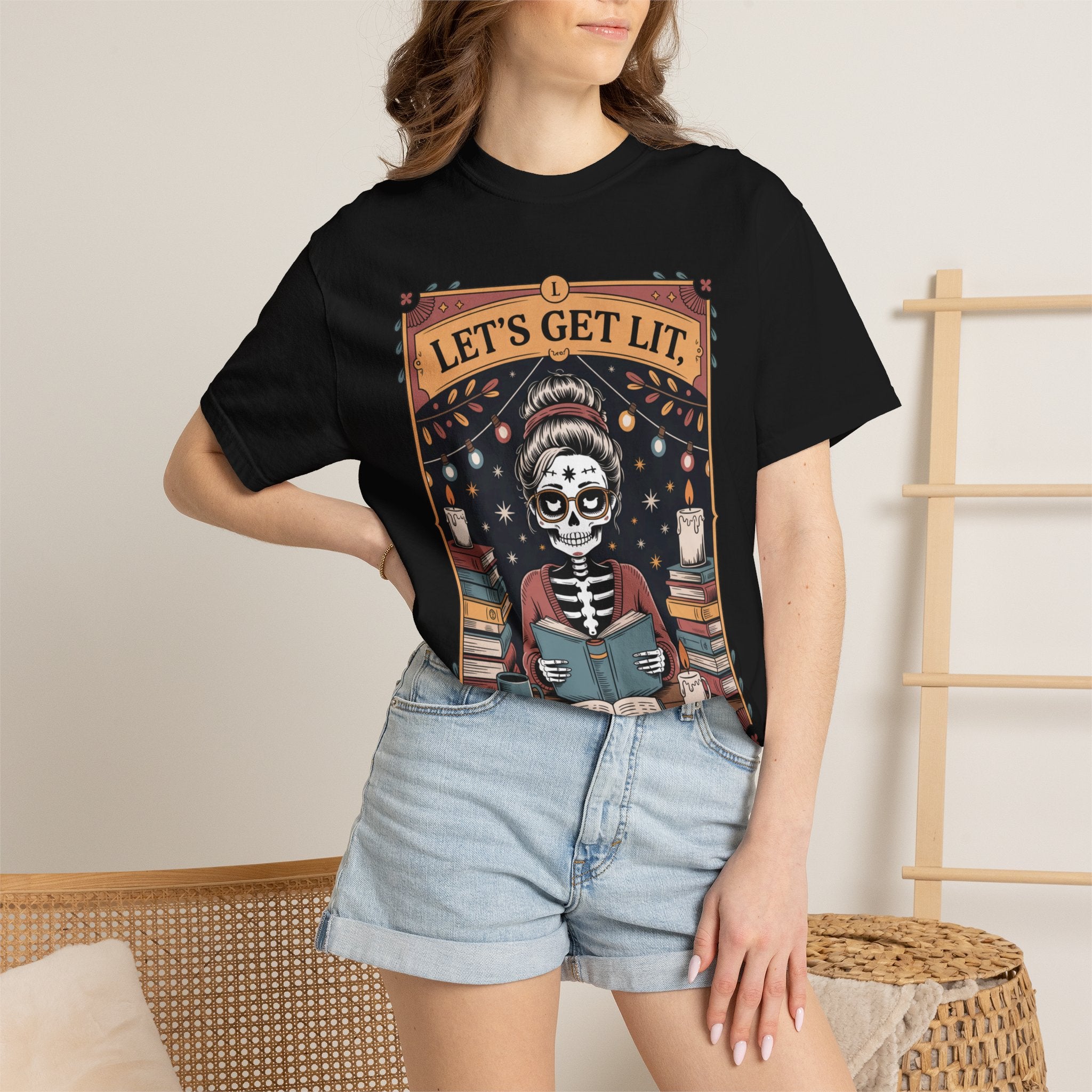 Person wearing a black t-shirt with a skeleton design and 'Let's Get Lit' text.