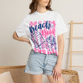 Woman wearing beach book club reading shirt at the beach