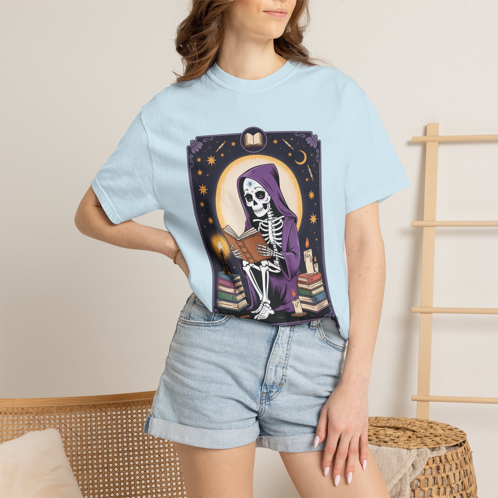 Person wearing a light blue t-shirt with a skeleton design, standing against a neutral background.
