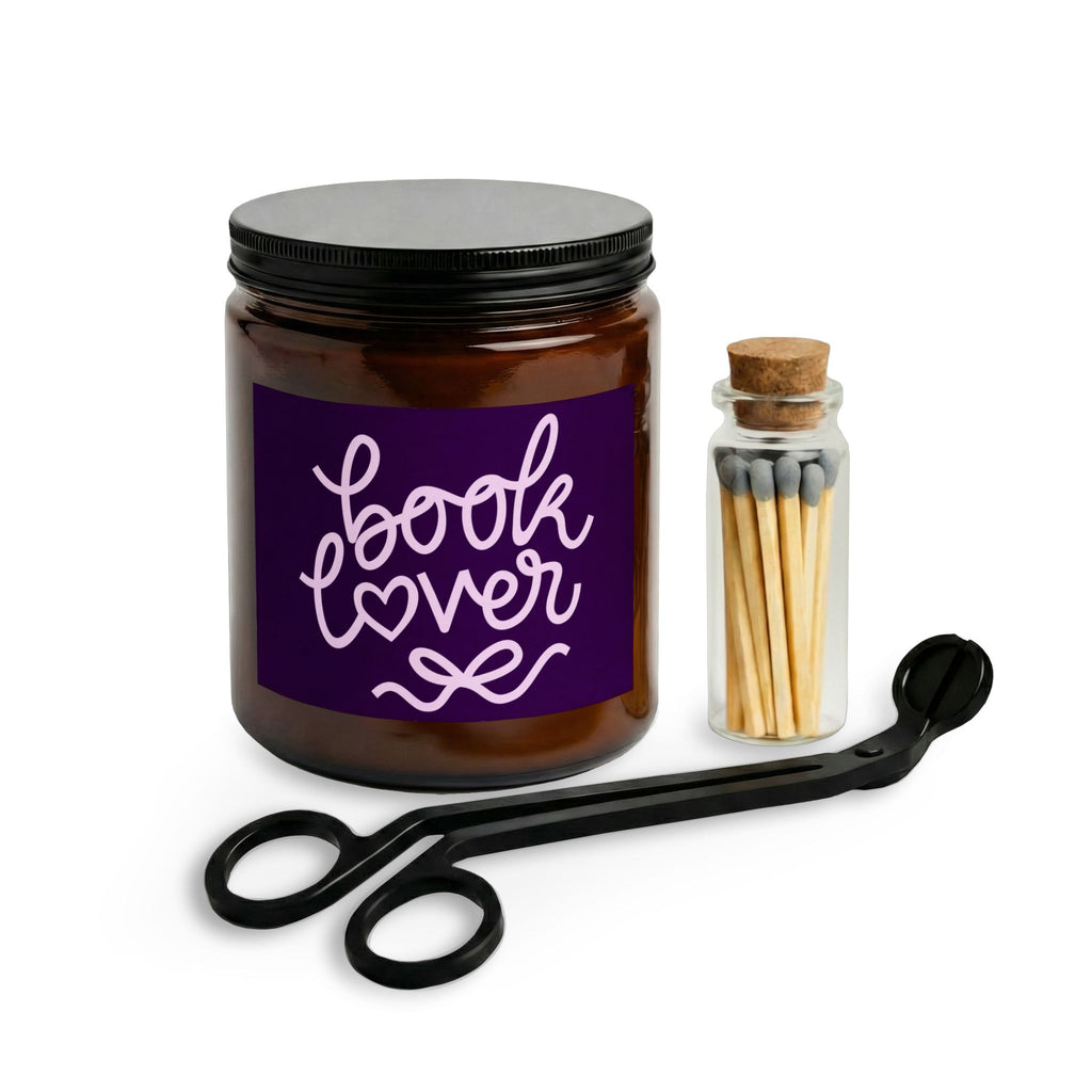 Candle jar labeled 'book lover' with a match holder and scissors on a white background