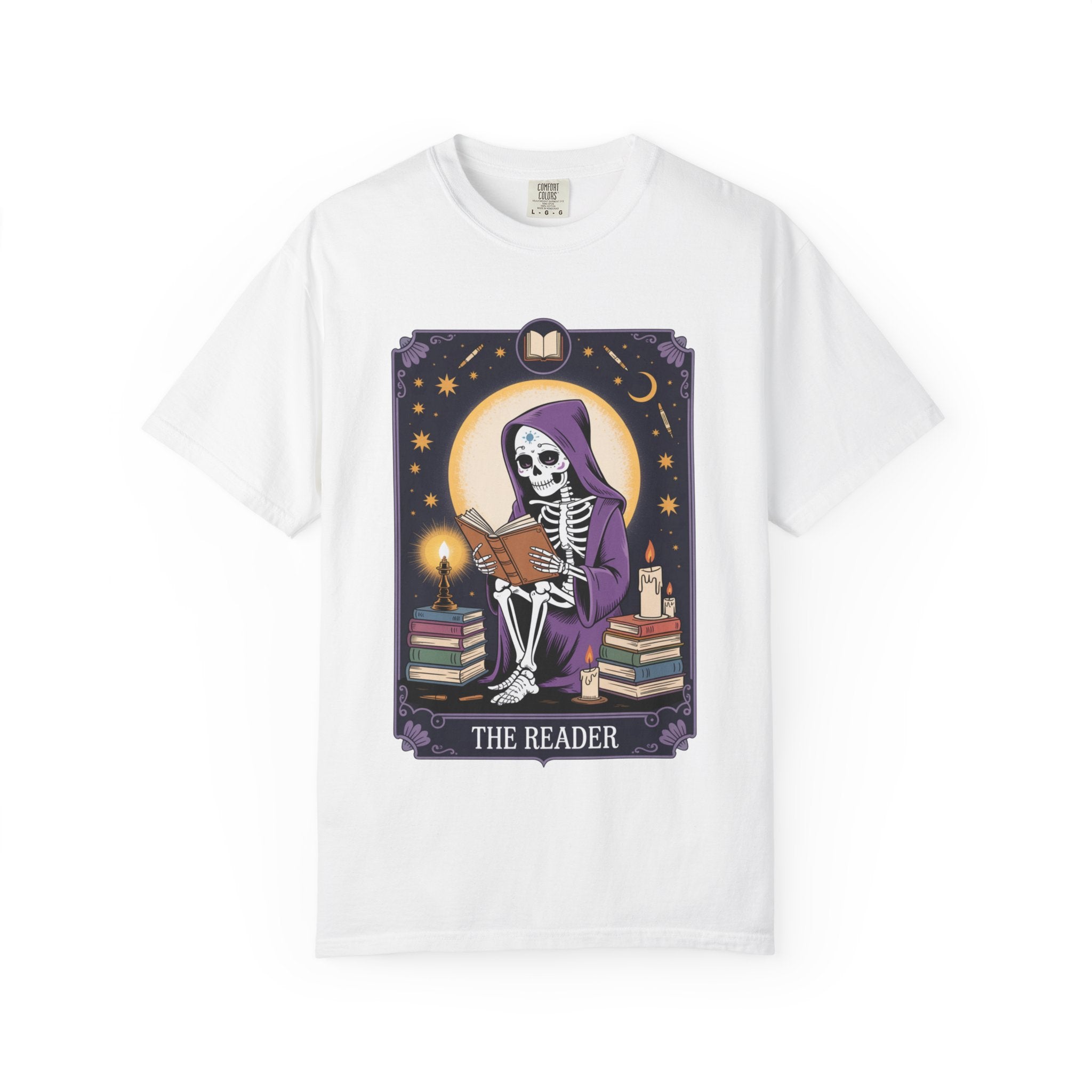 White t-shirt with a skeleton reading a book graphic and 'The Reader' text on a white background