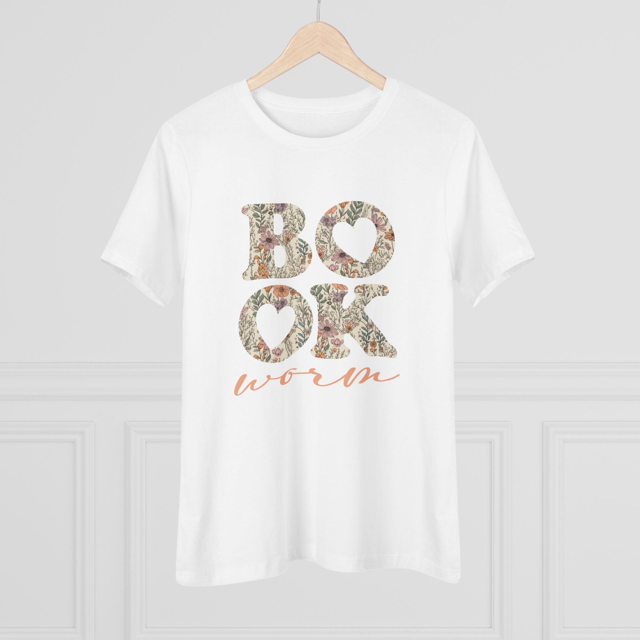 White t-shirt with floral text 'BOOK worm' on a hanger against a light gray background