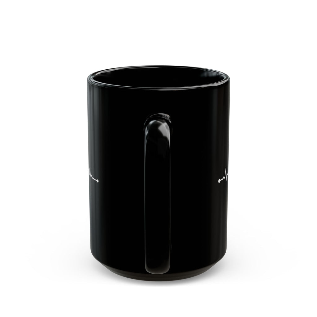 Black mug with colorful text on a white background