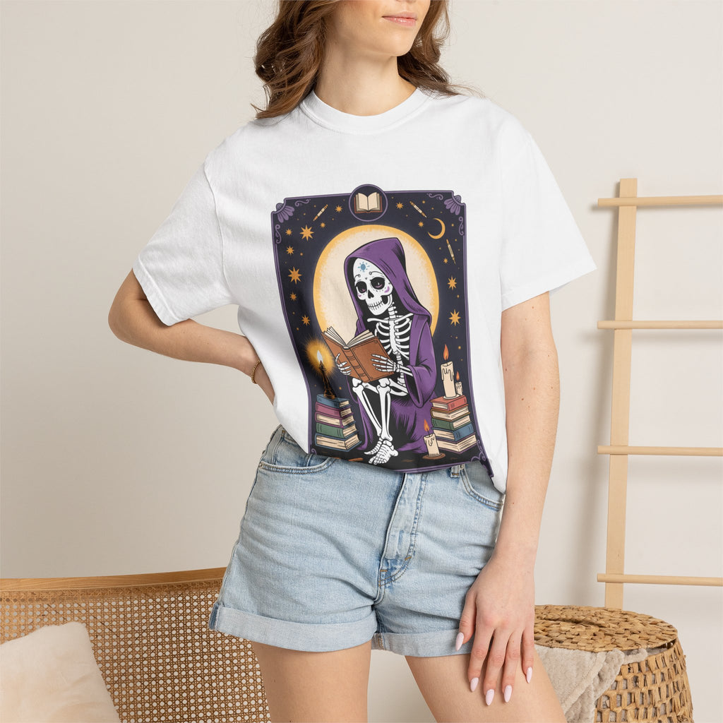 Person wearing a white t-shirt with a graphic design of a skeleton and books.