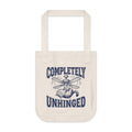 Tote bag with 'Completely Unhinged' text and propeller design on a white background