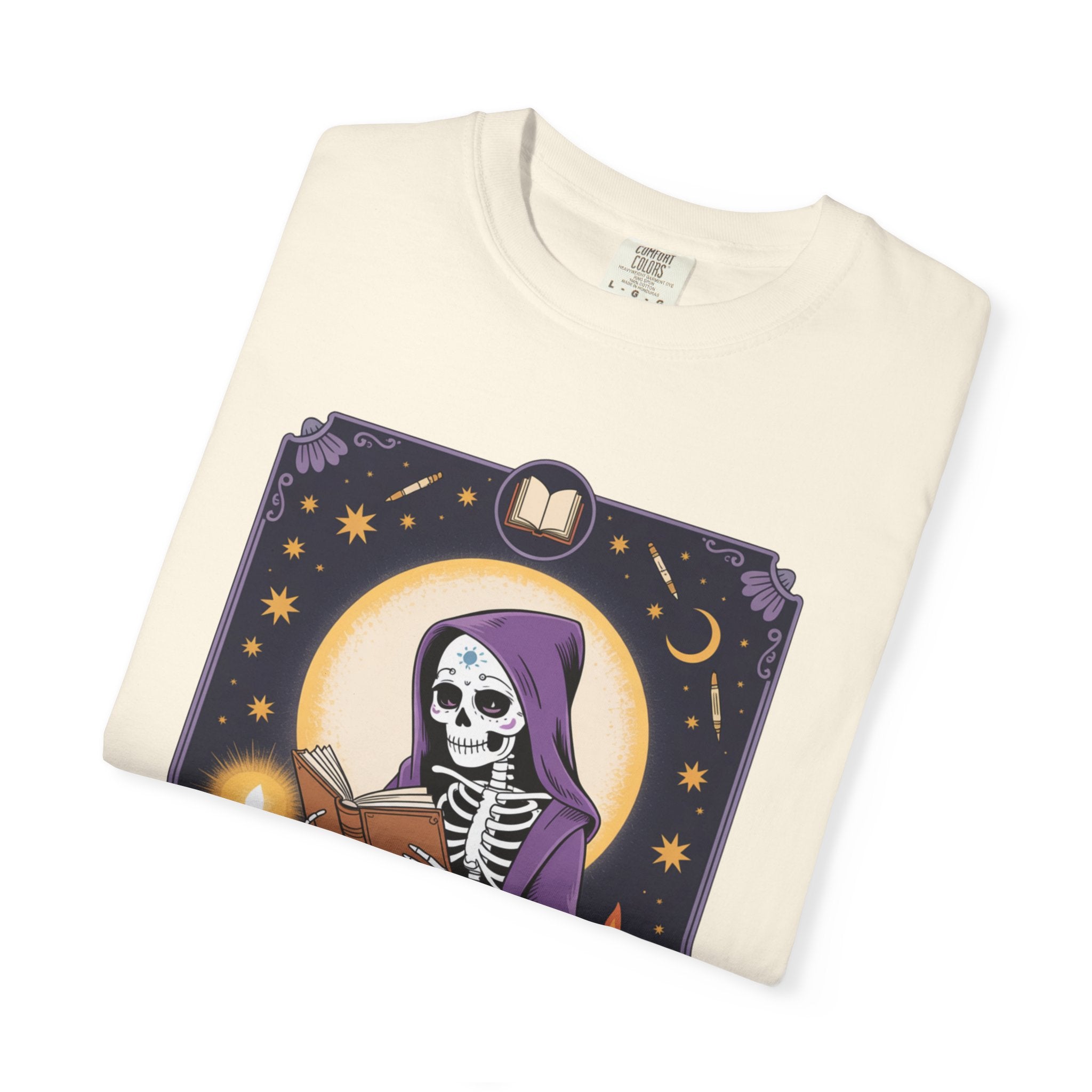 Folded t-shirt with a skeleton in a purple hood design on a white background