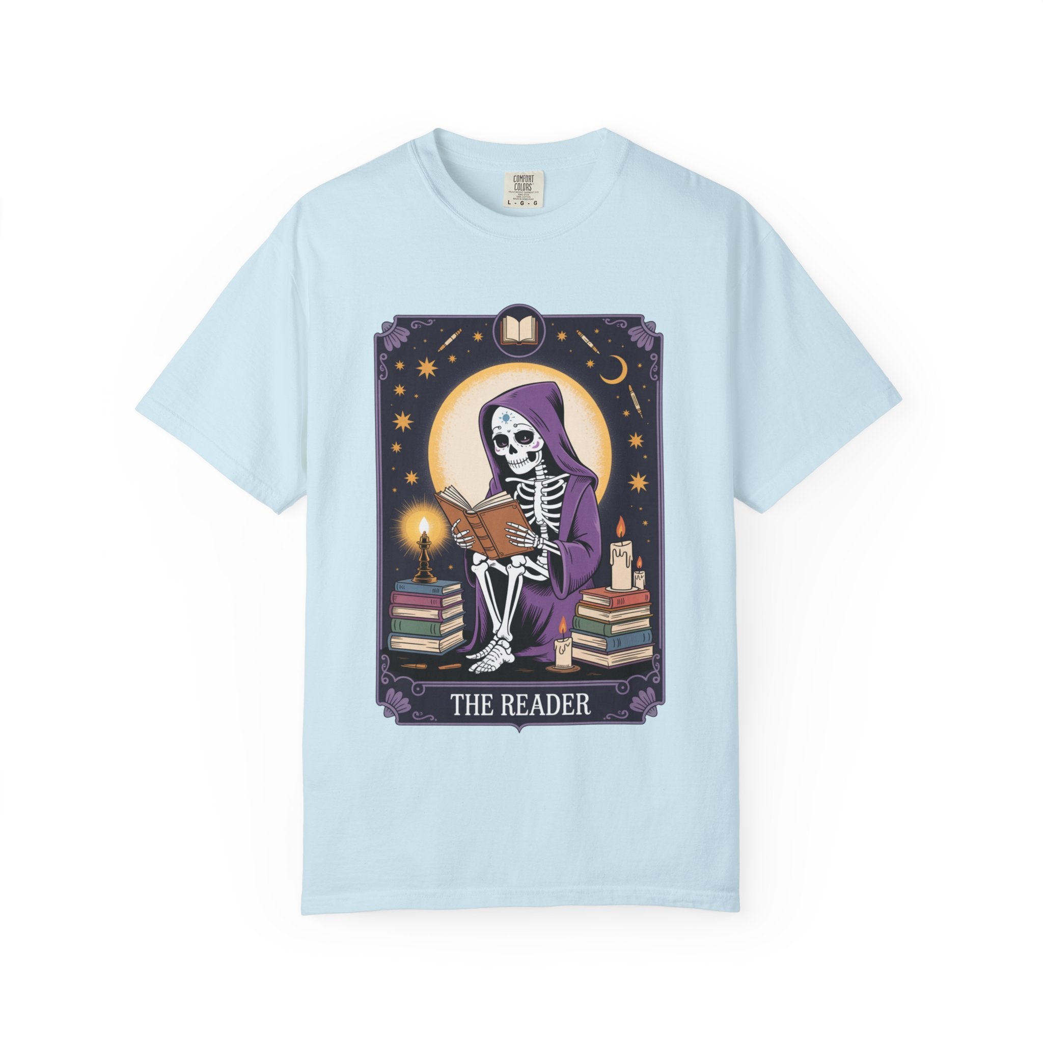 Light blue t-shirt with a skeleton reading a book graphic and 'The Reader' text on a white background