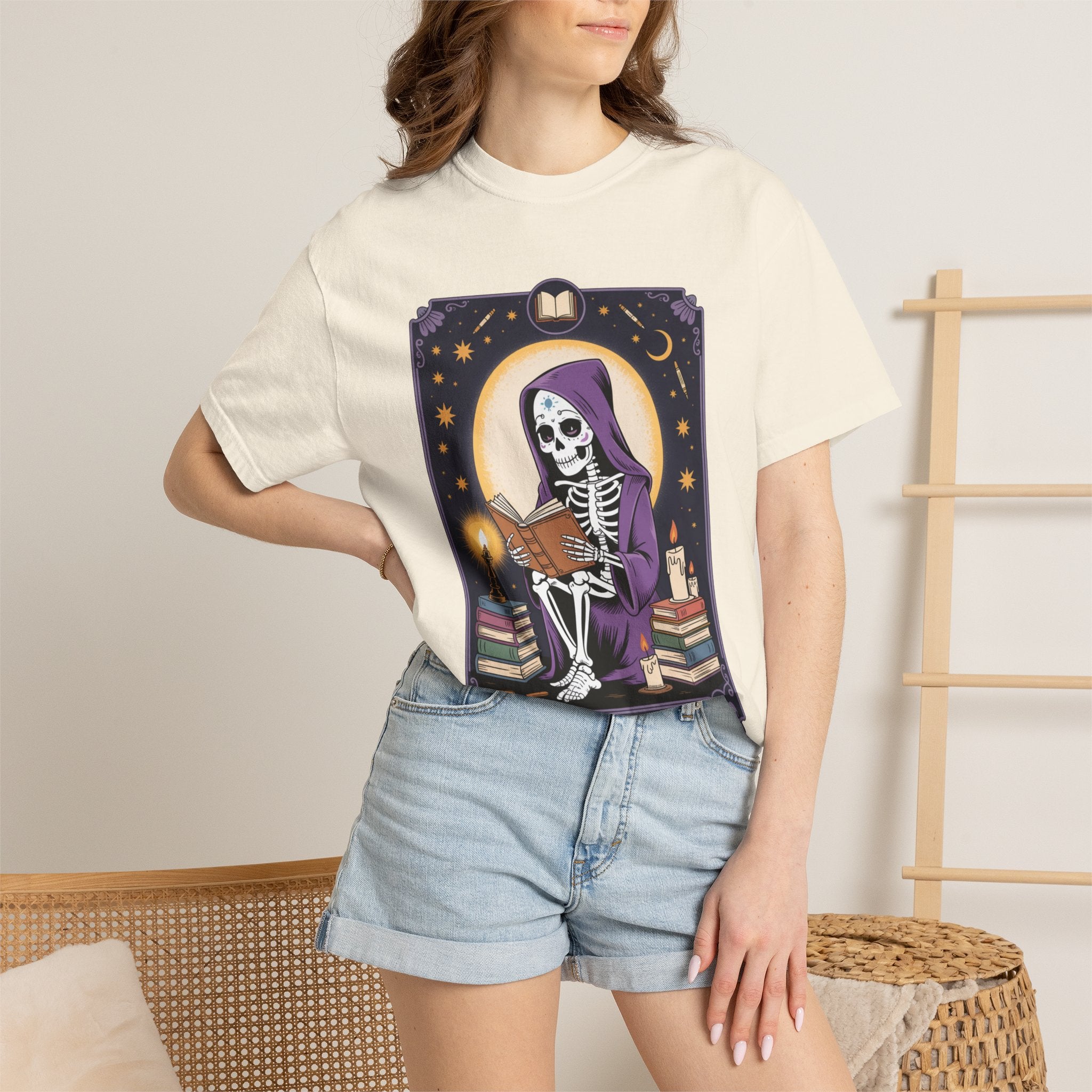 Person wearing a t-shirt with a skeleton design in a purple hood, standing against a neutral background.
