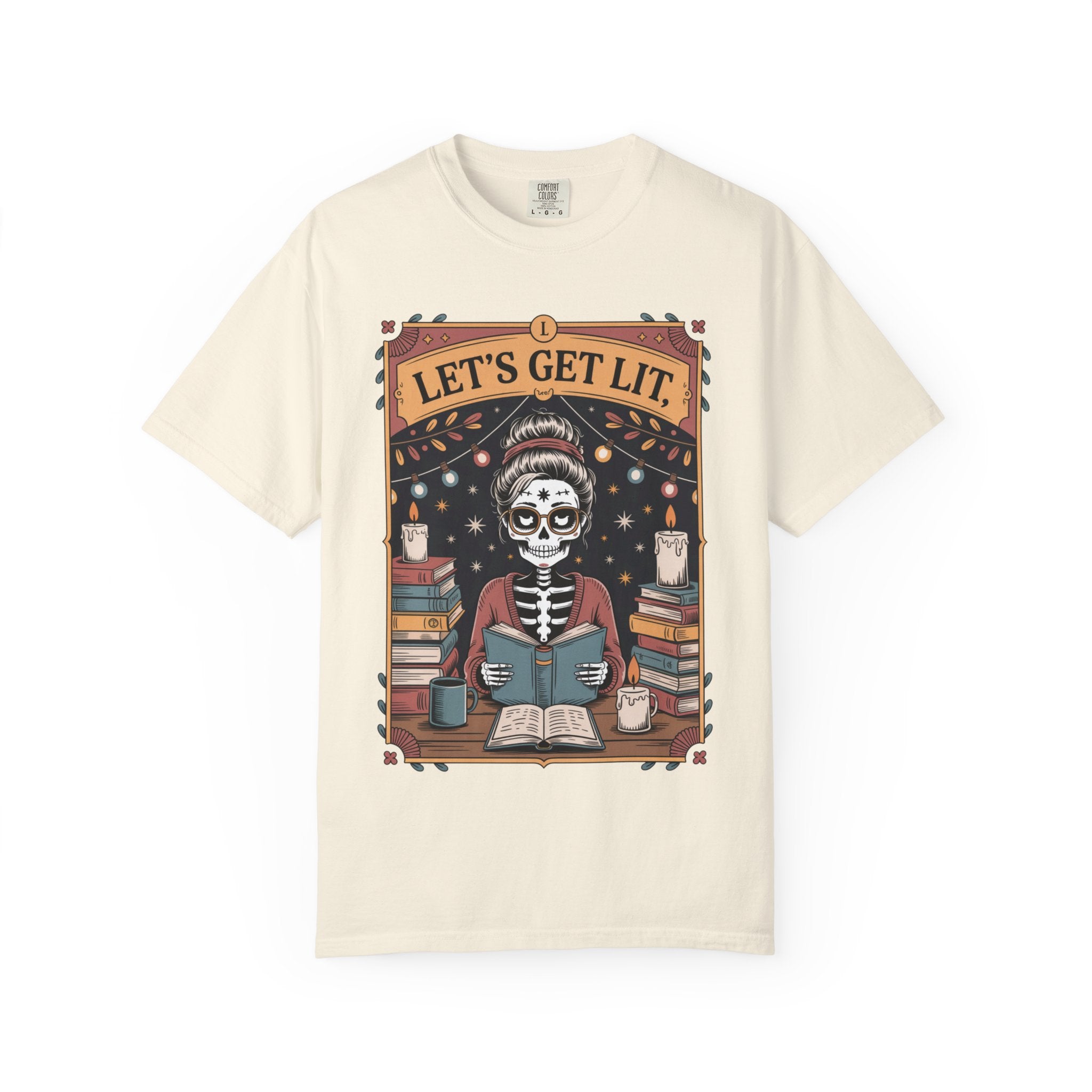 Beige t-shirt with a skeleton reading a book graphic and 'Let's Get Lit' text on a white background